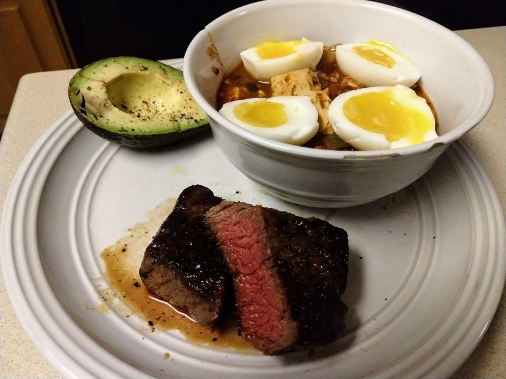 kimchi stew with steak, egg, and avocado