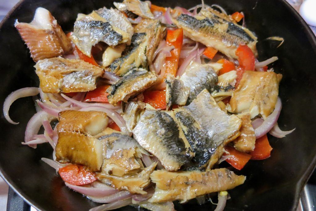 kippers and veggies in a heavy pan