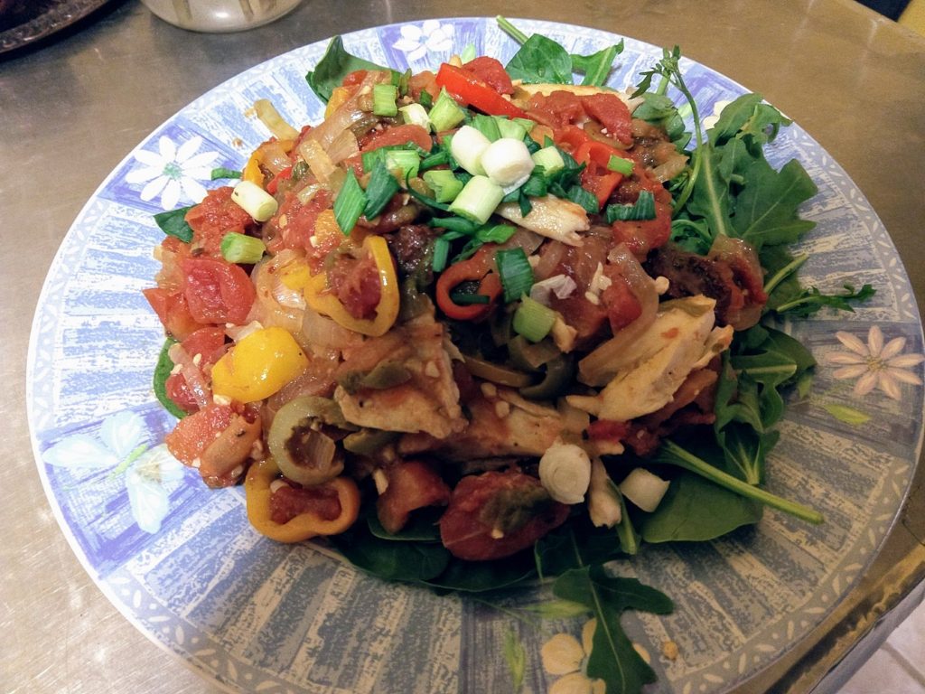 tilapia veracruz over greens