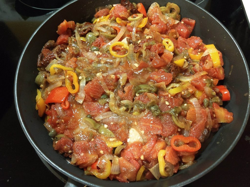 tilapia cooking in veracruz sauce