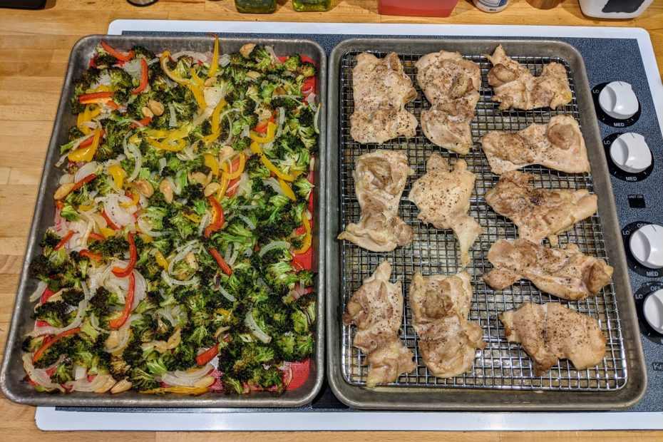 cooked chicken and vegetables on sheet pans