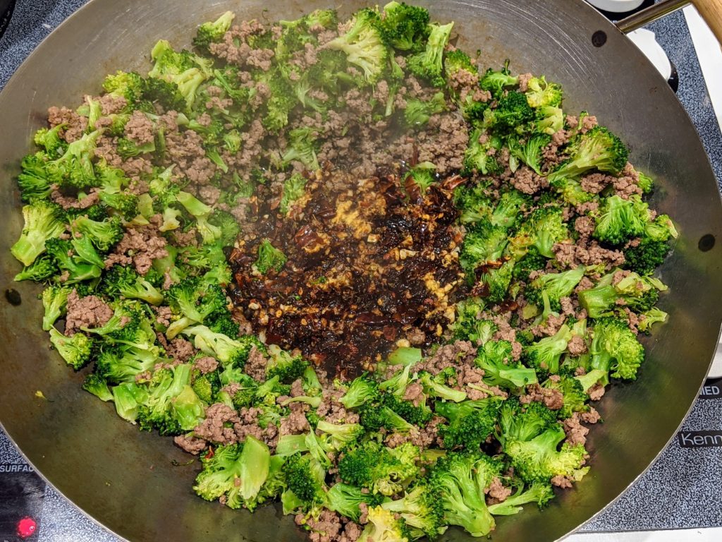 beef, broccoli, and mapo tofu flavor mixture in a wok