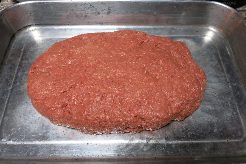 uncooked meatloaf in a roasting pan