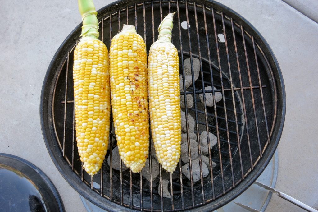 corn on a charcoal grill for elotes